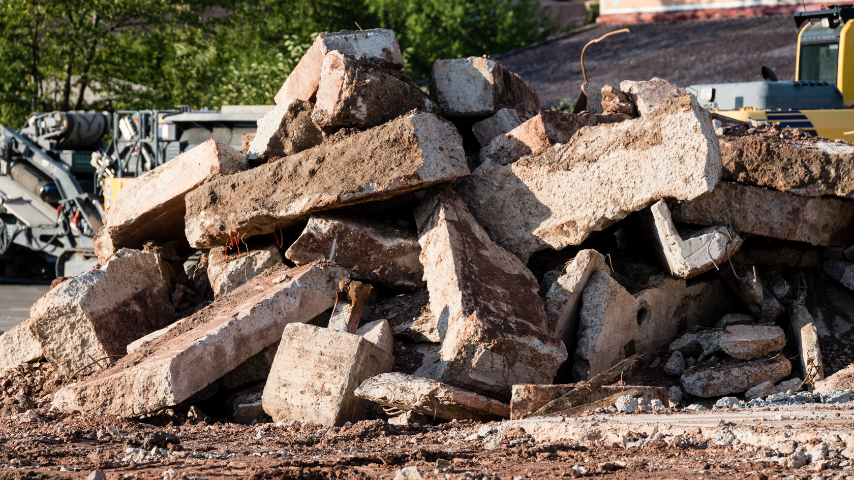 A pile of rocks sitting next to a bulldozer