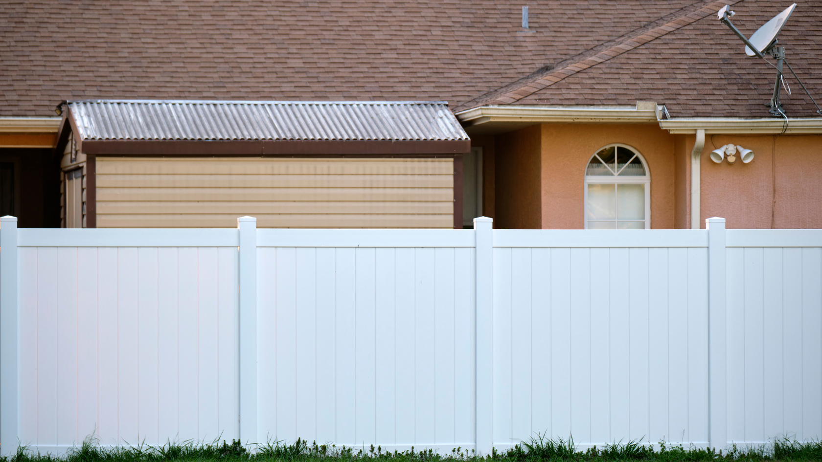 A white fence in front of a house